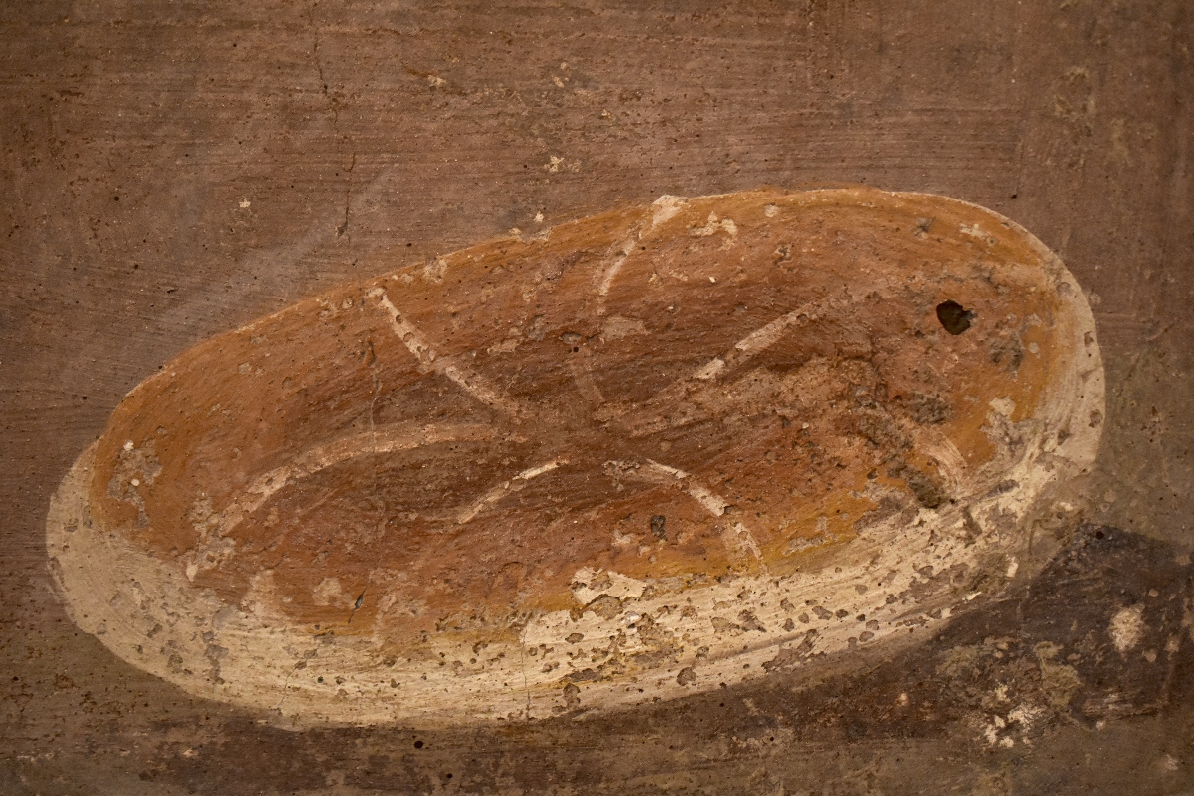 An ancient fresco from Herculaneum depicting a loaf of bread
