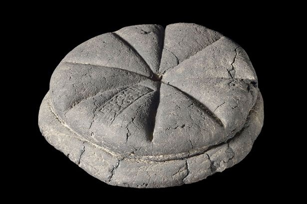 The carbonised ancient loaf from Herculaneum, with its segmented shape still visible