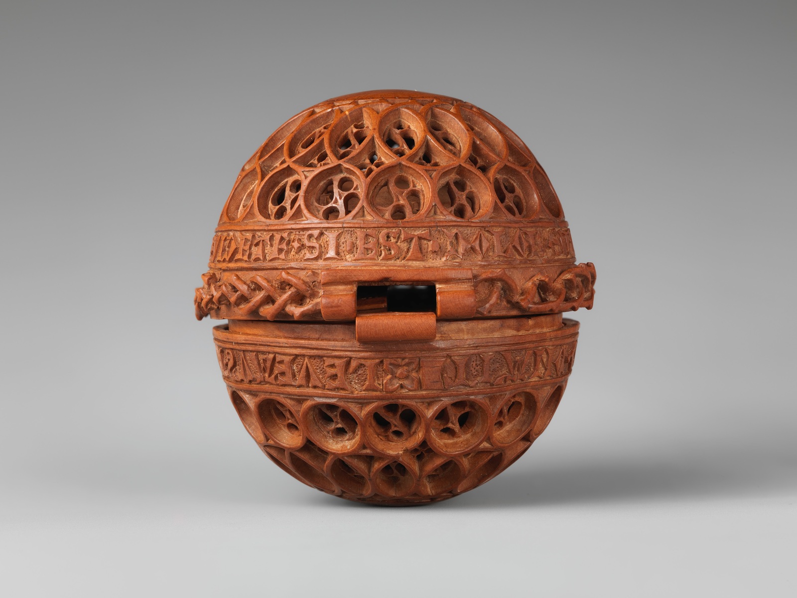 The closed boxwood prayer bead, less than six centimetres across — The Metropolitan Museum of Art, Open Access / public domain. Boxwood prayer bead 17.190.475. Original photograph; detail crop where indicated.
