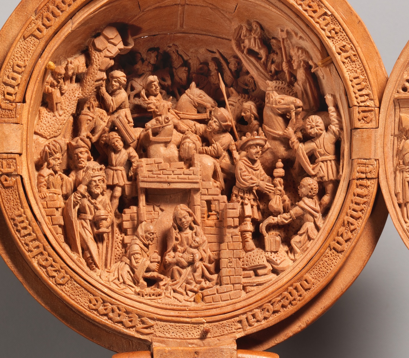 A detail crop of the tiny carved figures inside the prayer bead — The Metropolitan Museum of Art, Open Access / public domain. Boxwood prayer bead 17.190.475. Original photograph; detail crop where indicated.