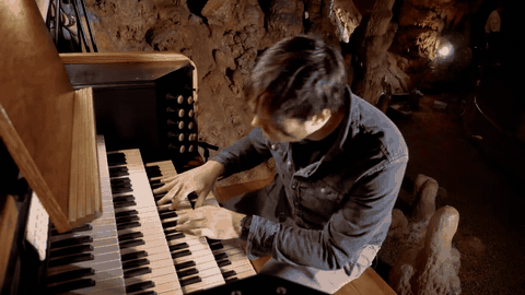 A rubber-tipped actuator beside its tuned stalactite in Luray Caverns — Rob Scallon / Luray Caverns. Documentary performance excerpt, unchanged sound and playback speed.