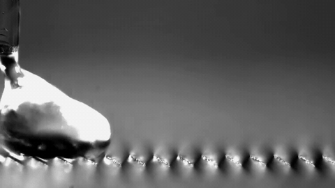 Slow-motion footage of a droplet travelling over asymmetric heated ridges — Science Friday / University of Bath researchers. Documentary excerpt; original playback speed retained.