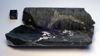 Actual drill-core pieces from the ancient natural nuclear reactors at Oklo — Naturhistorisches Museum Wien. Original Oklo drill-core specimen photograph resized; scale retained.