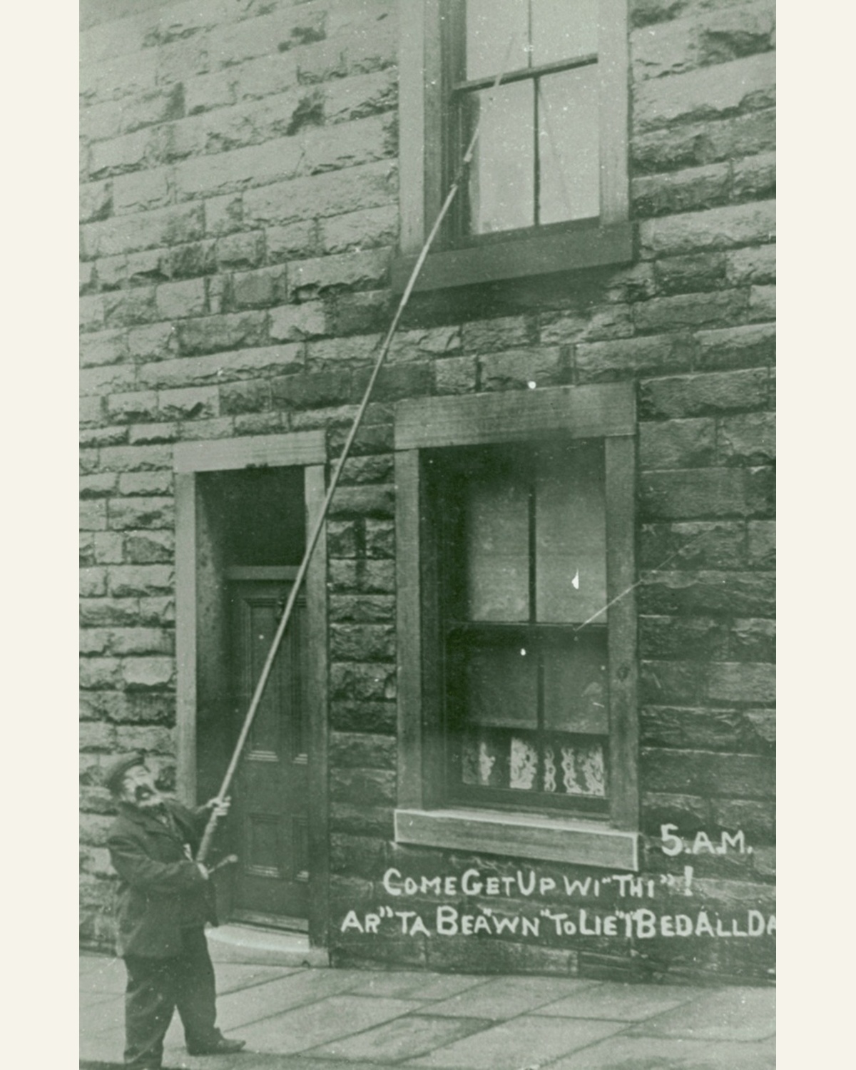 Archival photograph of a knocker-up tapping an upstairs window in Burnley, around 1900