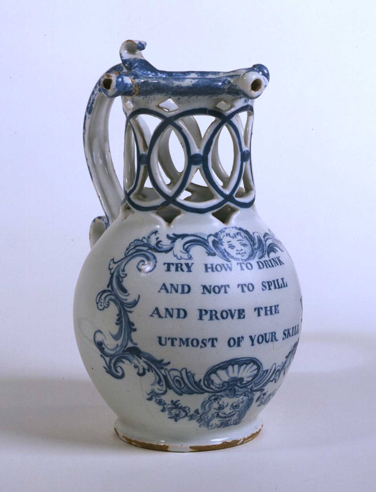 An 18th-century puzzle jug with pierced neck and multiple rim spouts — Victoria and Albert Museum, London. Bristol puzzle jug, about 1770–75, museum no. 275-1896. Original photograph.