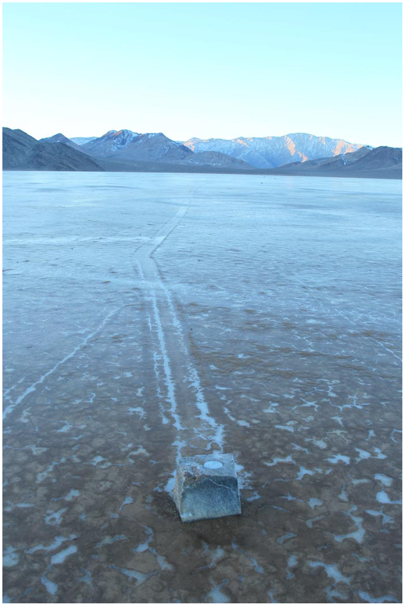 Research photographs documenting a rock moving while surrounded by thin ice