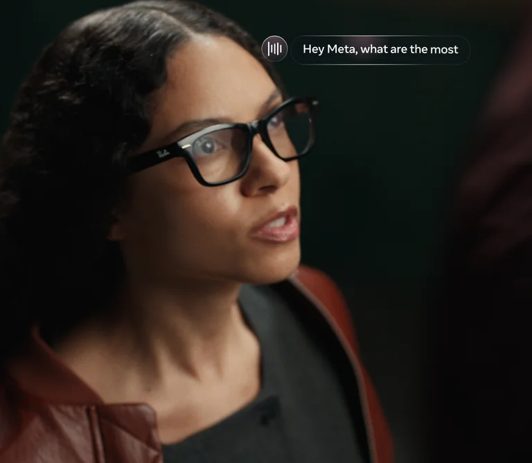 Official Meta promotional image for Ray-Ban Meta Audio. Preorder product. Person wearing Ray-Ban Meta Audio glasses with an example voice prompt